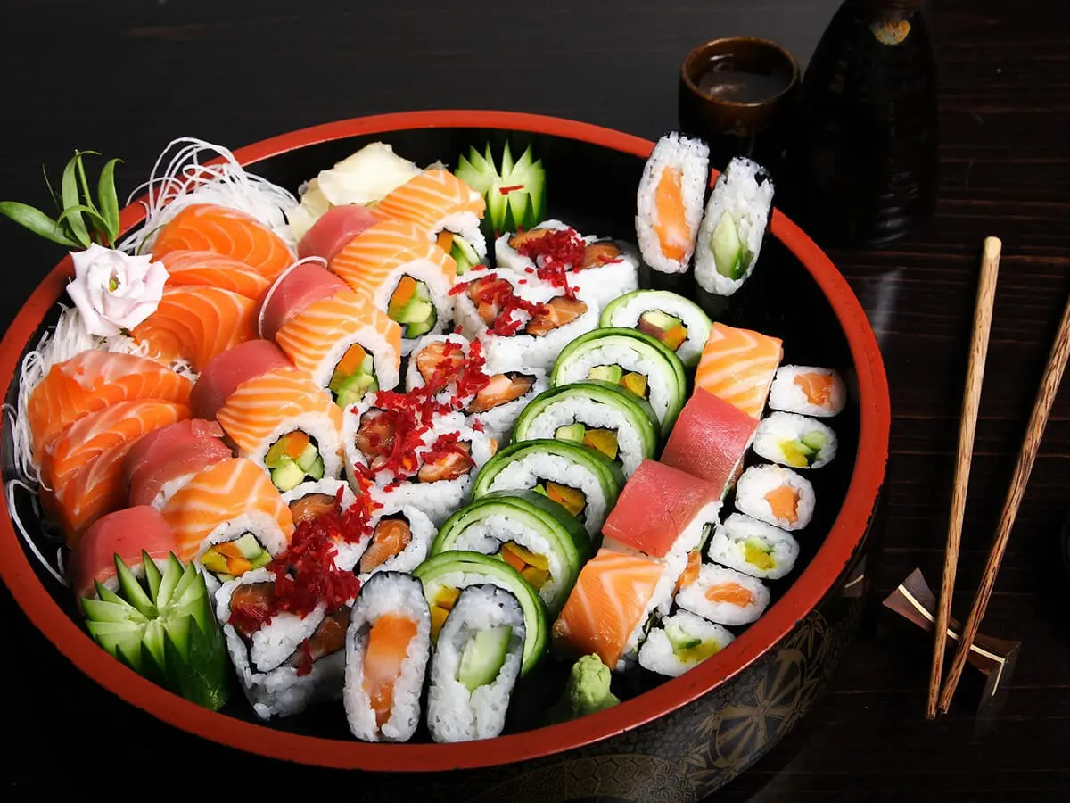 Deluxe Sushi Platter presents a large assortment of sushi rolls and nigiri sushi, neatly arranged in a round bowl - shaped platter at Hokkaido Sushi & Ramen, a Japanese restaurant in Vancouver